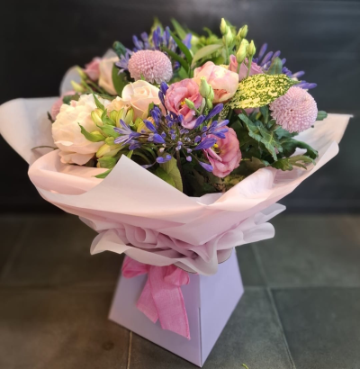 Ashleigh - A budding delight, complimented by greenery and presented in a gift box/bag. Beautiful flower bouquet hand delivered by the local florist.
