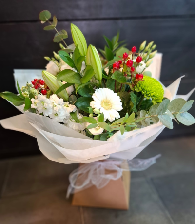 Classic Harmony - Share your sentiments with this beautiful arrangement of white and green blooms complemented by lush greenery. Presented in elegant wrapping.