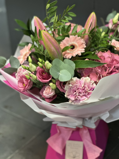 The Blush Bloom Edit - An elegant pink medley of premium blooms including lilies, hydrangea and lisianthus, hand-tied and presented in our signature gift box. A timeless statement of femininity and modern luxury.