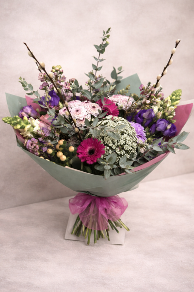 The Spring Muse - Soft lilacs, vibrant pinks and seasonal blooms, styled with eucalyptus and pussy willow for an airy, modern spring finish.