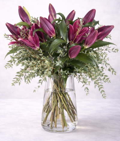 Plum Lily No. 2 - A luxurious plum lily vase arrangement with rich oriental lilies and soft eucalyptus, designed in a clear glass vase for an elegant, contemporary floral display.