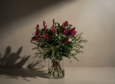 Plum Lily No. 2 - A luxurious plum lily vase arrangement with rich oriental lilies and soft eucalyptus, designed in a clear glass vase for an elegant, contemporary floral display.